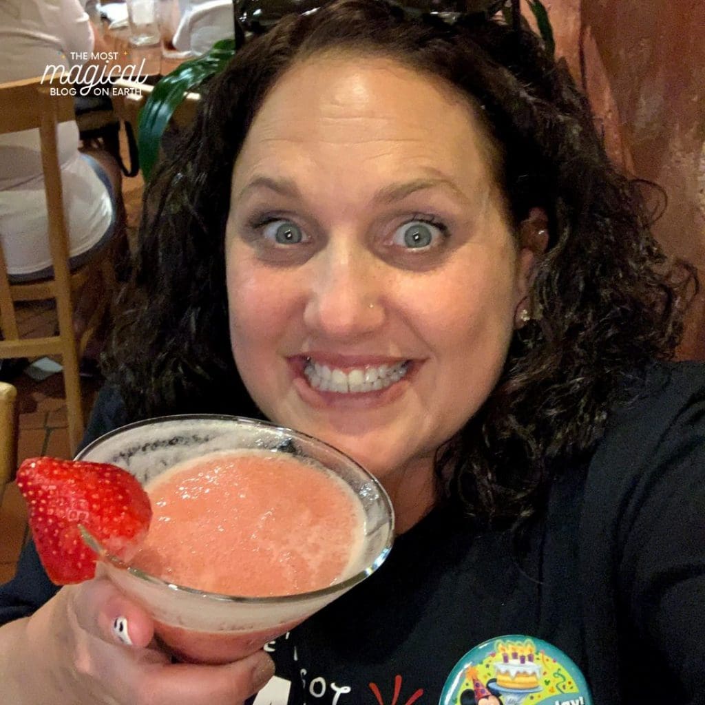 female author with pink adult drink in a martini glass
